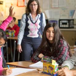 Girl raising her hand in a classroom