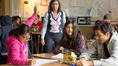 Girl raising her hand in a classroom