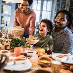 Family eating a meal and laughing