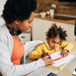 Mother homeschooling two kids